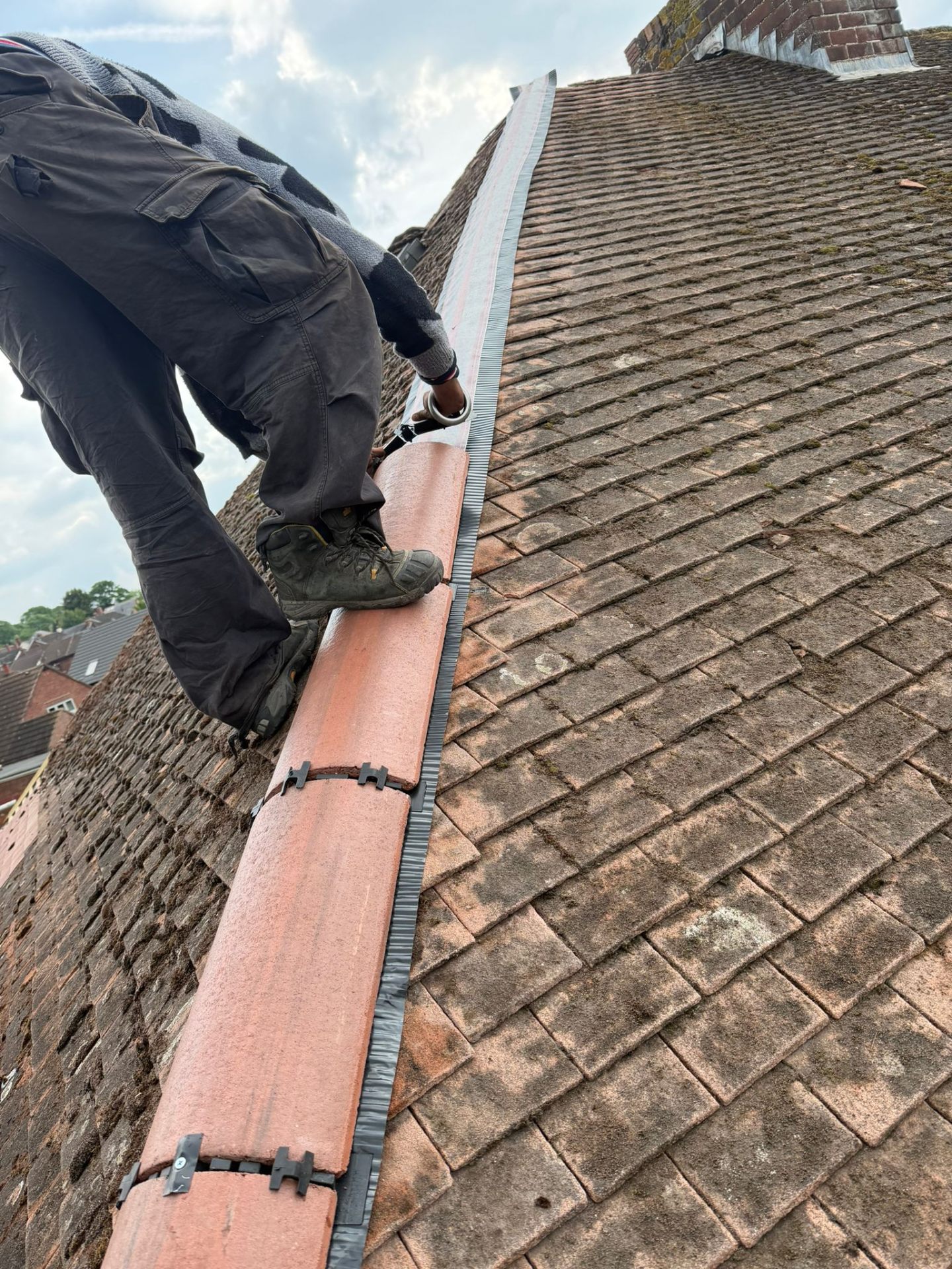 Roofer carrying out roof repairs